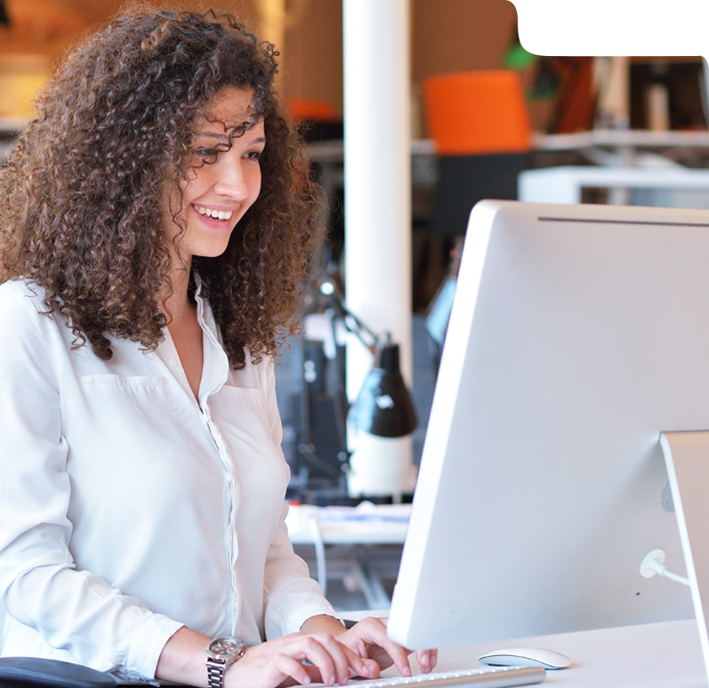 Woman using AI medical billing software at a desk.