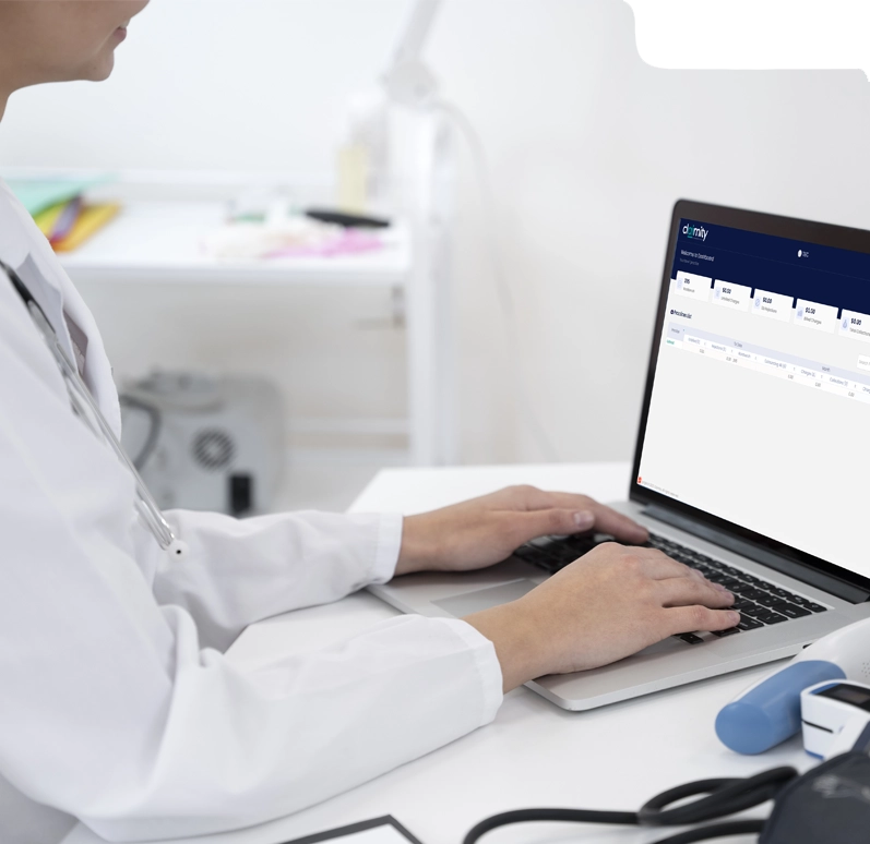 Doctor using medical billing software on laptop in clinic setting